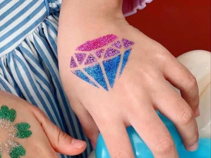 Glitter tattoos as guests arrive